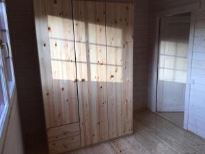 a room with wooden paneled walls and a door at Kāpas in Melnsils