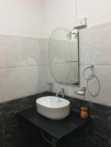 Kotuwella PahalaにあるLake view homestayの白い洗面台と鏡のあるバスルーム