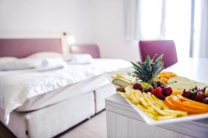 a plate of fruit on a table in a hotel room at Villa Palloma in Baška Voda