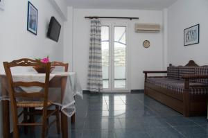 a living room with a table and a couch at Erato Apartments in Batsi +78 photos