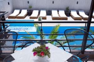a patio with a table and chairs and a pool at Ema Hotel in Sozopol