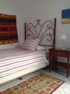 מיטה או מיטות בחדר ב-Casa Rural San Miguel Zufre
