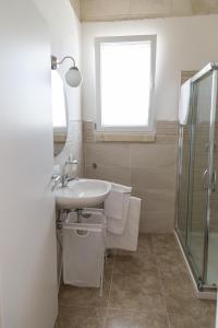 a bathroom with a sink and a shower at Masseria 25 Anni in Laterza +18 photos