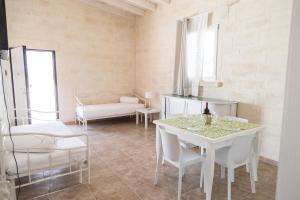 a living room with a white table and chairs at Masseria 25 Anni in Laterza
