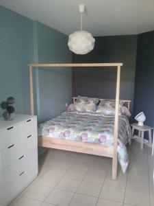 a bedroom with a bed and a white dresser at Agréable T2 à Bidart, centre bourg & plages à pied in Bidart