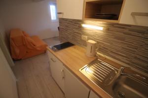 a kitchen with a sink and a counter top at Apartments Marinko in Stari Grad