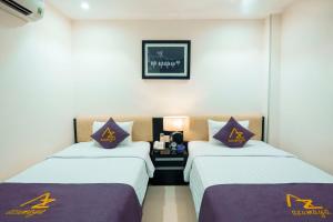 Postel nebo postele na pokoji v ubytování Azumaya Hotel Da Nang