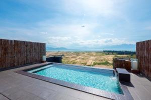 a swimming pool on a patio with a view at Azumaya Hotel Da Nang in Danang