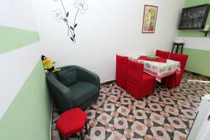 a living room with a chair and a table at Apartments Santin in Rovinj