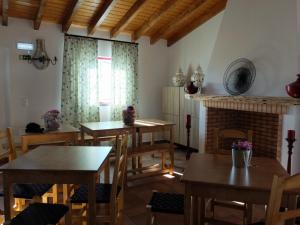 a dining room with tables and a fireplace at Vales do Alentejo in Bicos