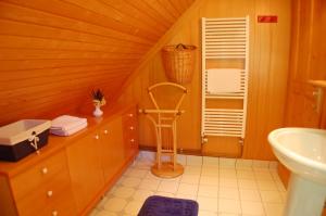 a bathroom with a sink and a chair in it at Chalet ApArt Kupljenik 12 A, Bled in Bohinjska Bela +102 photos
