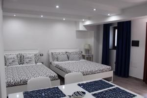 a room with two beds and a table at Villaggio Silvia in Castellabate +116 photos