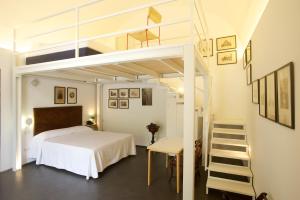a bedroom with a loft bed and a ladder at Sopra il Limoneto in Cetara
