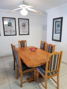 comedor con mesa de madera y sillas en Unit 30 The Bridge - FAMILY UNIT IN A PRIME SPOT ON THE GROUND FLOOR, en St Lucia
