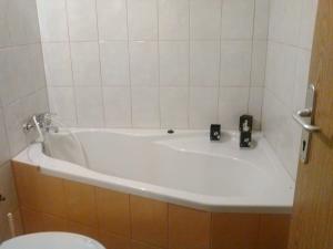 a bathroom with a white tub and a toilet at Apartment Lavinia in Zadar +9 photos