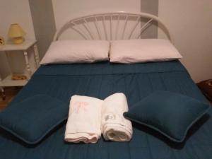 a bed with two towels and pillows on it at Apartment Lavinia in Zadar