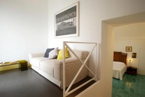 a living room with a white couch and a mirror at Sopra il Limoneto in Cetara