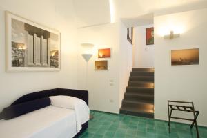 a bedroom with a bed and a stair case at Sopra il Limoneto in Cetara