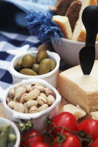 a table topped with different types of cheese and vegetables at Villa Valentina in Levanto