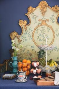 a table with fruits and plates and a mirror at Villa Valentina in Levanto