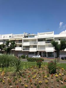 an apartment building with flowers in front of it at Appartement à royan in Royan
