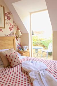 a bedroom with a bed with a red and white blanket at The Library House B&B in Ironbridge