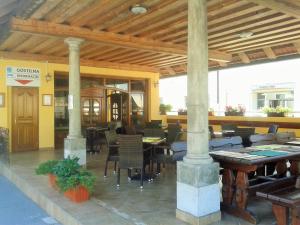 a restaurant with tables and chairs in a building at Guesthouse Jersin in Logatec