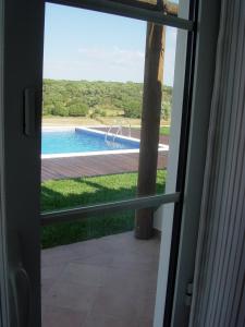 a view of a swimming pool through a door at Vales do Alentejo in Bicos