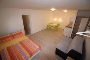 a bedroom with a bed and a table with chairs at Apartments Marinko in Stari Grad