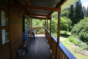 veranda coperta di una casa con tavolo di Nibelheim Self Catering Cottage a Hogsback