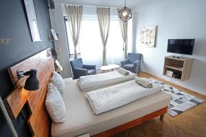 ブダペストにあるd.FIVE Inspire Apartment Budapestのベッド2台とリビングルームが備わる客室です。