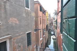 a view of a canal between two buildings at Tiepolo Charme Houses in Venice