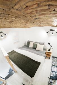 a bed in a room with a wooden ceiling at Designer loft at the Great Synagogue in Budapest