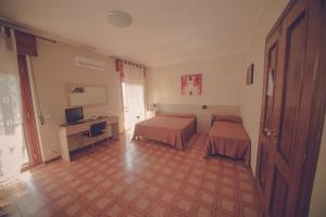 Postel nebo postele na pokoji v ubytování Cassiodoro Rooms Affittacamere