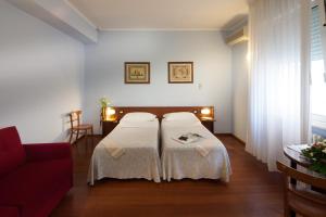 Postel nebo postele na pokoji v ubytování Hotel Mariani + 37 fotografií