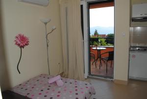 a room with a room with a table and a balcony at Apartments Ivan in Zadar