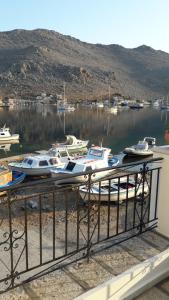 a bunch of boats are docked in a harbor at Kamares Studios in Symi