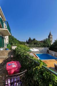 a yard with a chair and a swimming pool at Villa Lavanda in Podgora