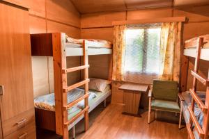 a room with two bunk beds and a window at Camp Vary - Vítkova Hora - Veitsberg in Karlovy Vary