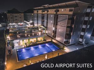 an overhead view of a building with a swimming pool at Gold Airport Suites in Lat Krabang