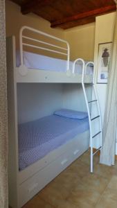 a bunk bed with a ladder in a room at Residence Sottomonte in Golfo Aranci