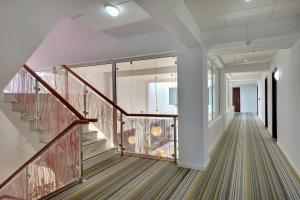 a hallway with a staircase with glass railings at Zodiaco in Quarteira