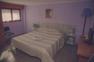 Postel nebo postele na pokoji v ubytování Cassiodoro Rooms Affittacamere