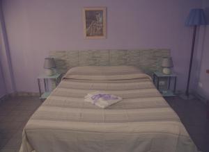 Postel nebo postele na pokoji v ubytování Cassiodoro Rooms Affittacamere