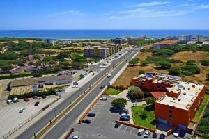 an aerial view of a city with the ocean at Zodiaco in Quarteira