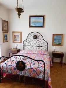 a bedroom with a bed with a colorful comforter at Ilm Cagliari in Cagliari