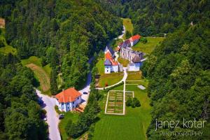 an aerial view of a house on a hill next to a river at Mala Kmetija in Slovenske Konjice
