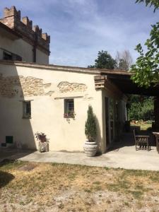 a white house with a potted plant in front of it at CaStella B&B in Monte Colombo
