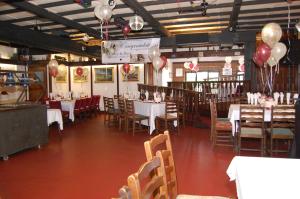 a dining room with tables and chairs and balloons at Hogs Head Hotel in Nottingham