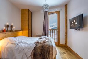 a bedroom with a bed and a window at Résidence Santa Terra in Tignes